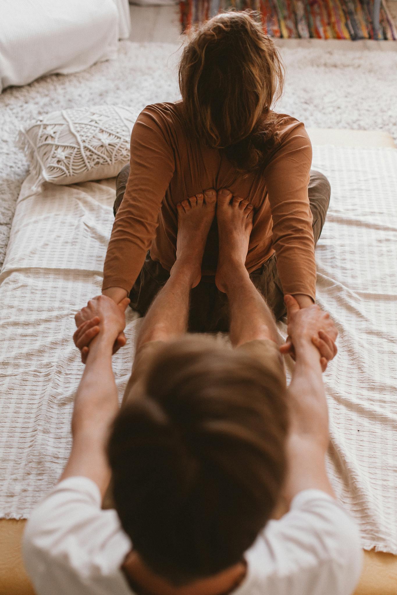 A couple engaged in a therapeutic massage session indoors, showcasing connection and relaxation.